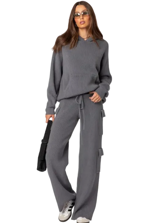Woman wearing a gray tracksuit on a white background